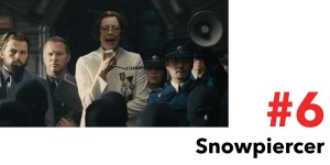 Snowpiercer is #6 in the Top 10 Post Apocalyptic Movies on Netflix. Pictured, a woman speaks through a megaphone surrounded by thugs.