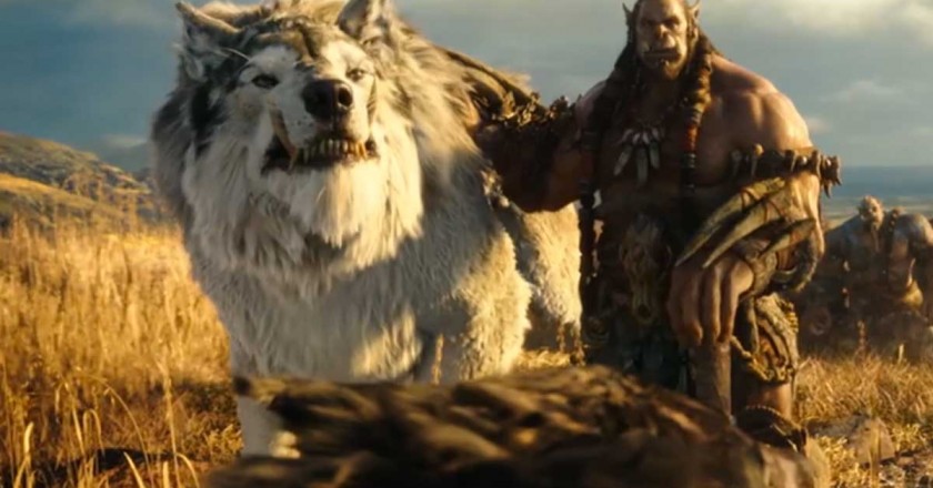 A large Orc pets his enormous wolf