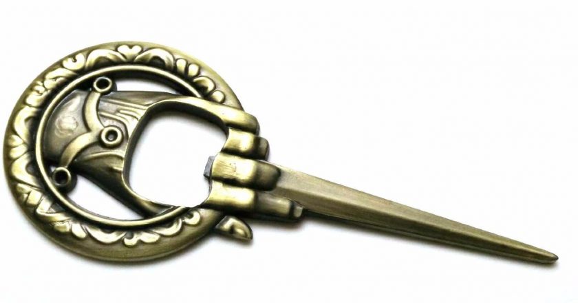 a metal bottle opener that looks like the game of thrones hand of the king pin