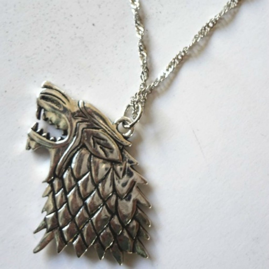a silver looking direwolf necklace