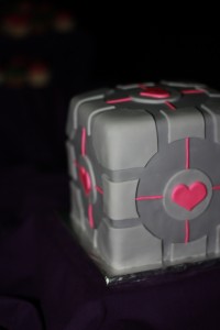 A wedding cake that looks like the companion cube from Portal video game