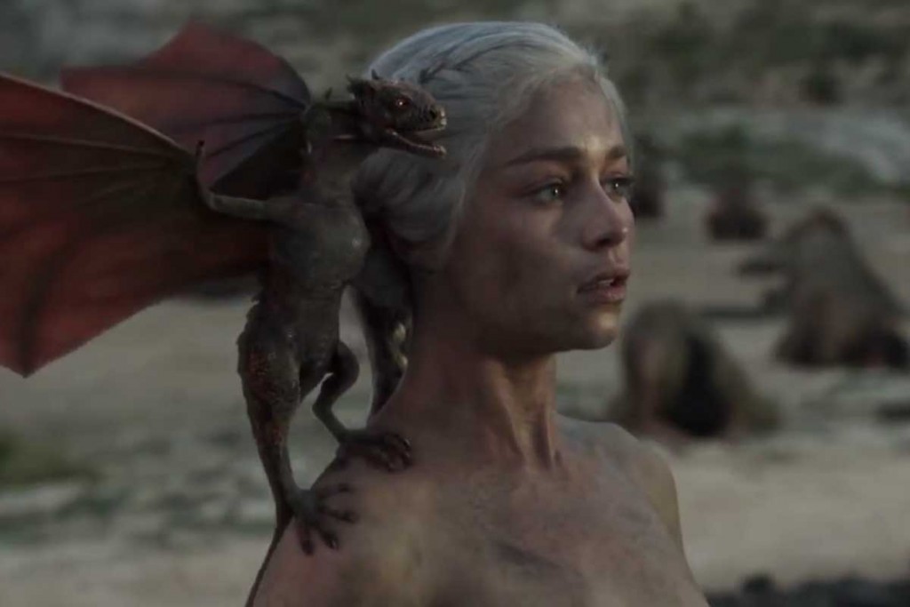 A dragon sits on the shoulder of Danaerys Targaryen