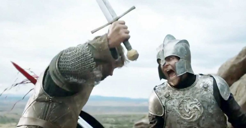 A man in targaryen armor runs another man through with his sword.