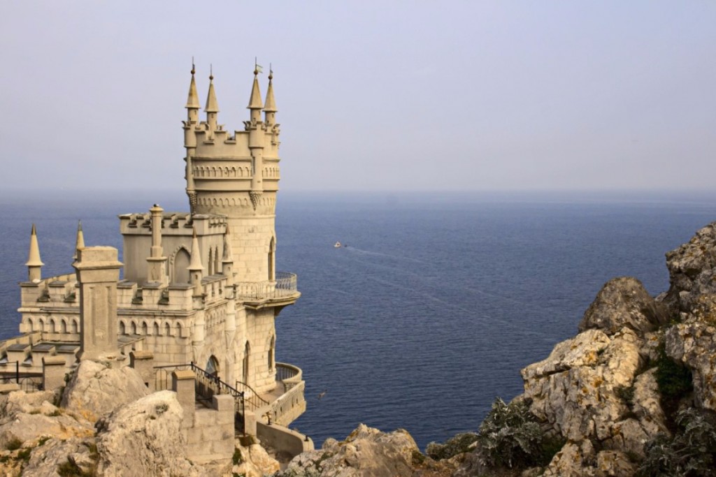an ancient castle stands by the ocean