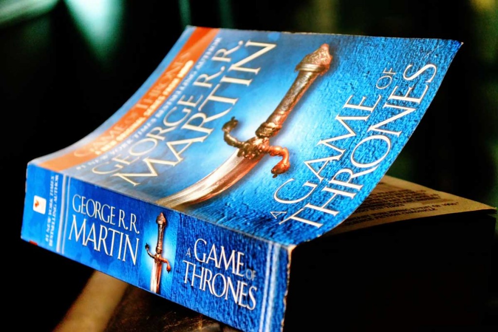 the game of thrones book sits on a table