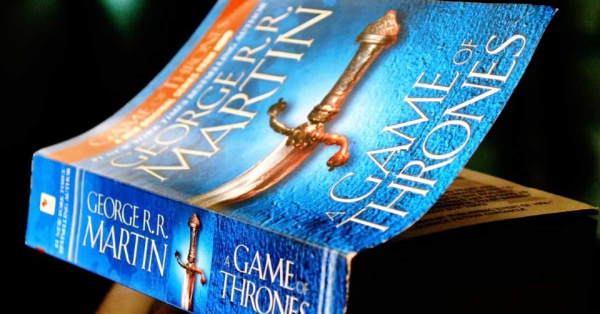 the game of thrones book sits on a table
