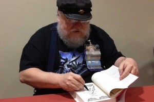 Goerge RR Martin signs a book for a fan