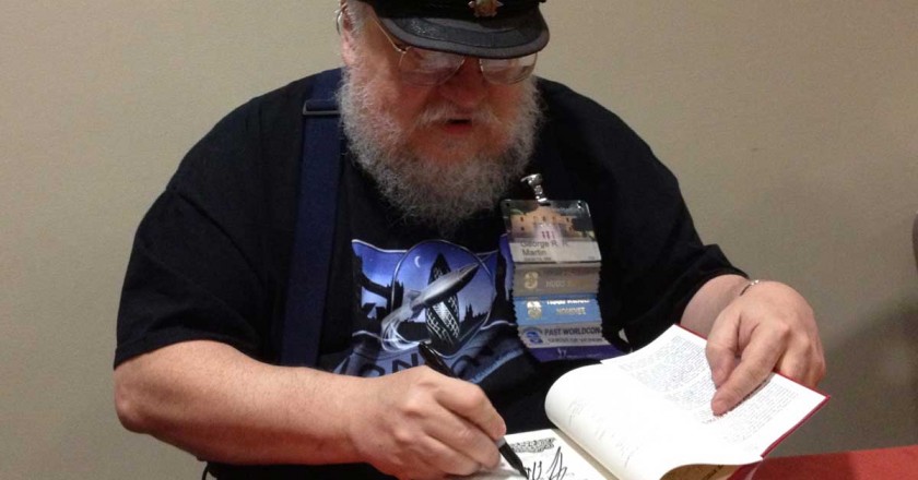Goerge RR Martin signs a book for a fan