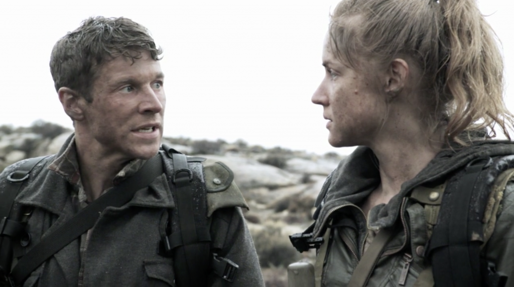 a man and a woman talk in a post apocalyptic world