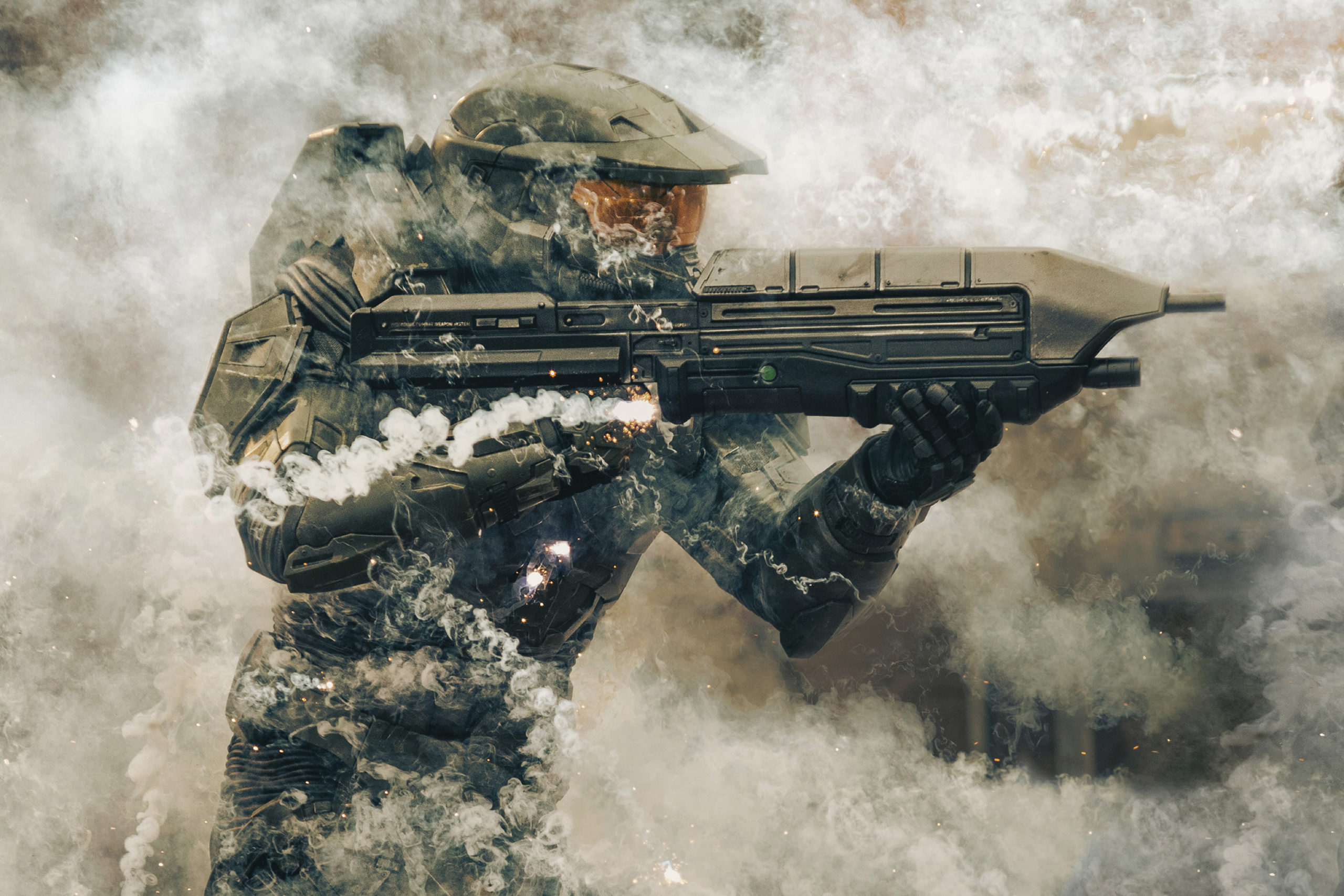 A Spartan aims his assault rifle with smoke everywhere